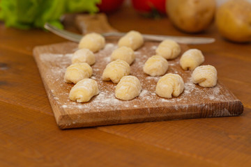 Uncooked homemade gnocchi on cutting board