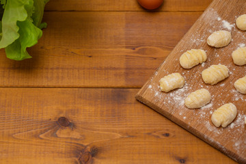 Uncooked homemade gnocchi on cutting board