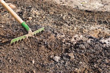 Raking the ground, preparing soil to sowing, spring gardening