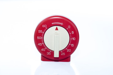 Red, vintage kitchen timer on white background