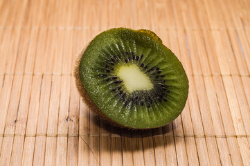Half of kiwi on rustic background