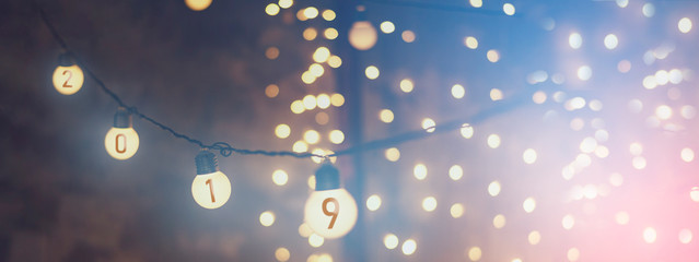 New Year background 2019. garlands and lanterns that hang on a single wire and shine with a soft, warm light creating an evening New Year's Eve atmosphere. An ideal background for wallpapers 