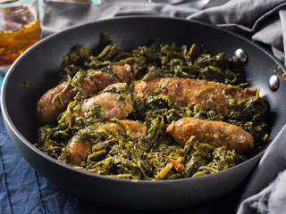 Italian sausages with rapini broccoli in a skillet