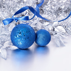 Christmas border with blue balls and ribbon on silver background square