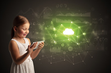 Adorable girl working on tablet with cloud technology concept
