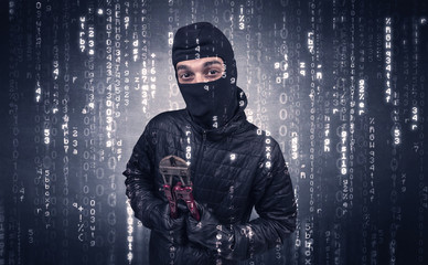 Burglar in action with encoded concept and his tools in his hand. 