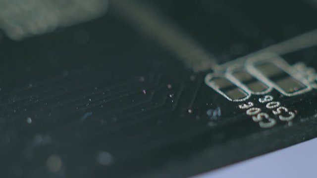 Computer parts macro closeup. Camera moving above structures of chips, microchips and processors on used board.