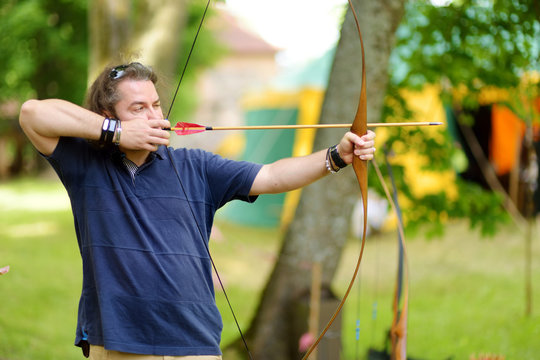 Young male shooting a bow on an annual Medieval Festival, held in Trakai Peninsular Castle.