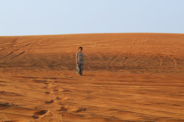 silhouette of a girl in the setting sun in the desert in the United Arab Emirates