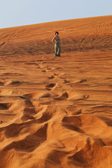 silhouette of a girl in the setting sun in the desert in the United Arab Emirates