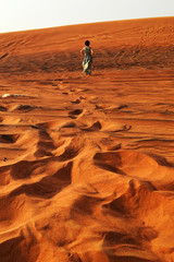 silhouette of a girl in the setting sun in the desert in the United Arab Emirates