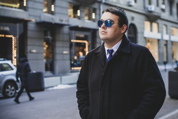  Young plus size man in city streets, plump people concept, one in big city life. Image of overweight businessman at downtown 