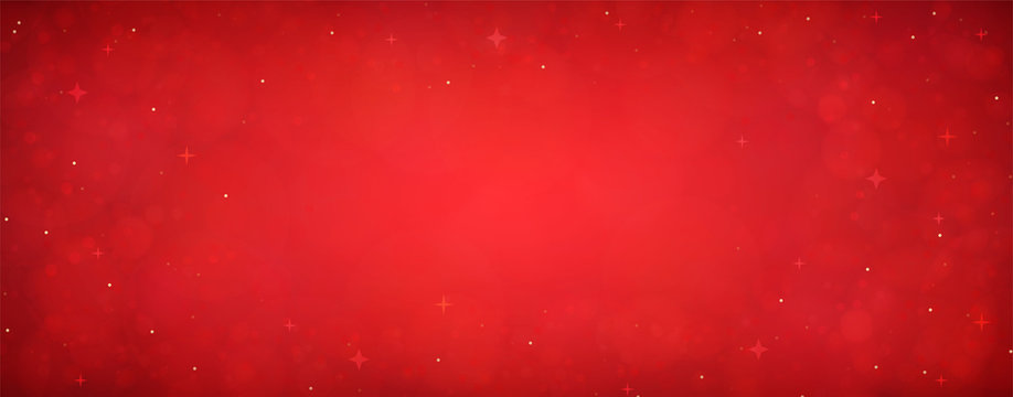 Red christmas glitter background with stars. Festive glowing blurred texture.