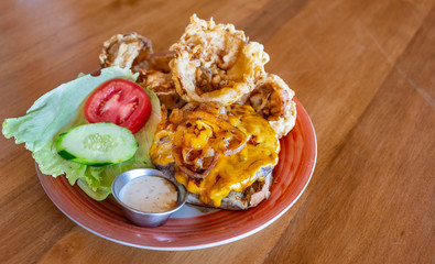 Gourmet cheeseburger and handmade onion rings