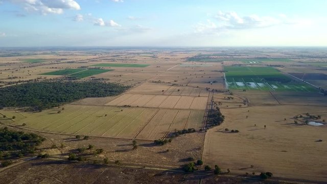 Aerial view over rural Australia, characterized by agricultural land, carved into a neat patchwork of green and gold