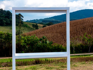 View of mountains with the white wooden frame