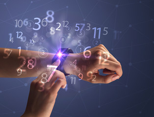 Close up female naked hand wearing smartwatch and numbers around