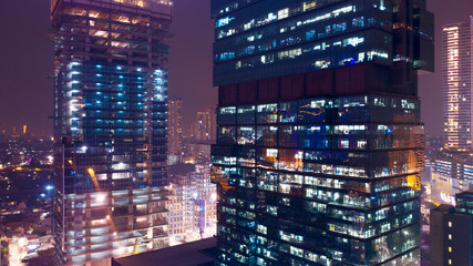 Fototapeta na wymiar High buildings with night light in Jakarta