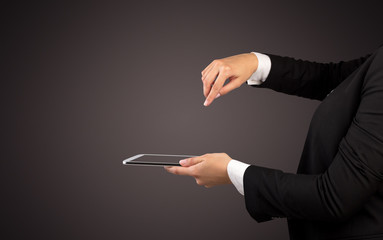 Female hand in suit holding tablet with no wallpaper
