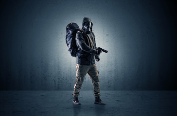 Bad agent in a dark room with arms on his hand and gas mask
