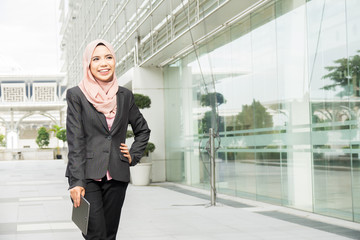 Young muslim woman use smart phone at outside office area.