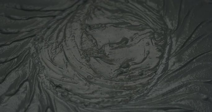 Slow motion closeup mixing dark gray micro concrete plaster