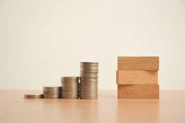 Stack of coins with wood block.