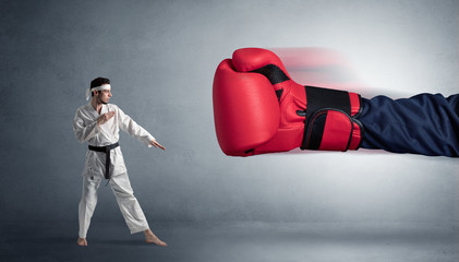 Little man fighting with a giant red boxing glove
