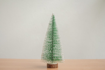small christmas tree with copy space on wood floor.minimal.
