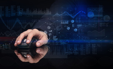 Hand using wireless mouse with financial concept on dark background
