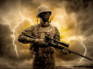 Armed soldier standing in rainy obscure weather
