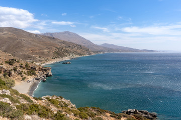 Landscape on the island of Crete, Greece with a wide view over the mountains with a bay and a beach in the front
