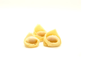 Raw Tortellini pasta on white background