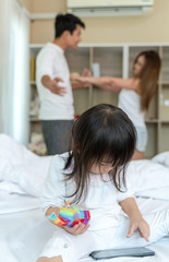Obraz na płótnie Canvas parents quarrel in bedroom with daughter