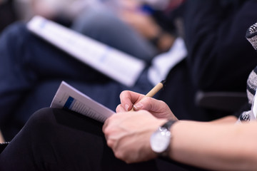 business people taking notes