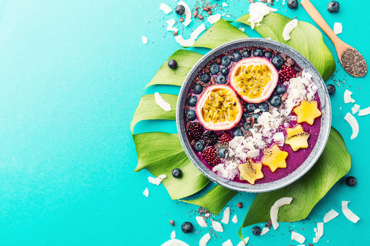 Smoothie Acai Bowl Served In Bowl On Blue Table