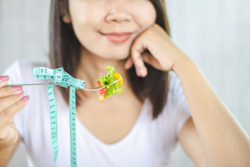 Asian woman eating healthy food salad for dieting  concept 