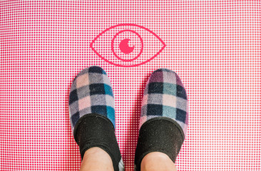 man with a slippers standing next to eye icon 