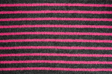 Fototapeta premium The texture of the wool fabric in black and red stripes