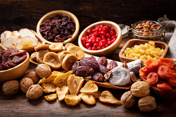 dried fruits on wooden table - obrazy, fototapety, plakaty