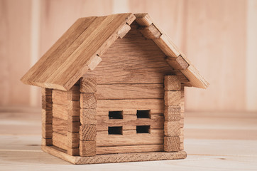 Obraz na płótnie Canvas A wooden toy folding house shot large on a wooden background