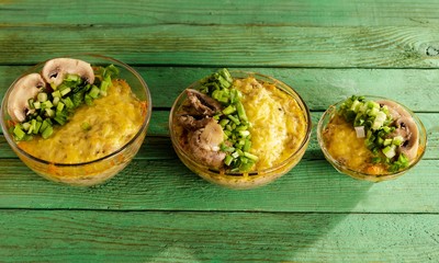 Three portions of Julien on a wooden green table.