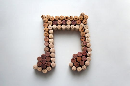 Wine corks music note abstract composition isolated on white background from a high angle view