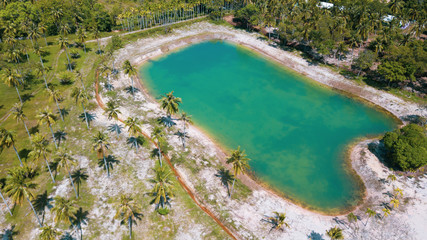 Fototapeta na wymiar Aerial drone view of beautiful lagoon pond on tropical island during sunny summer day