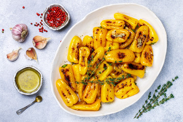 Roasted bell pepper with olive oil, garlic, thyme and spices. Gourmet snack. A side dish to meat and fish. Selective focus