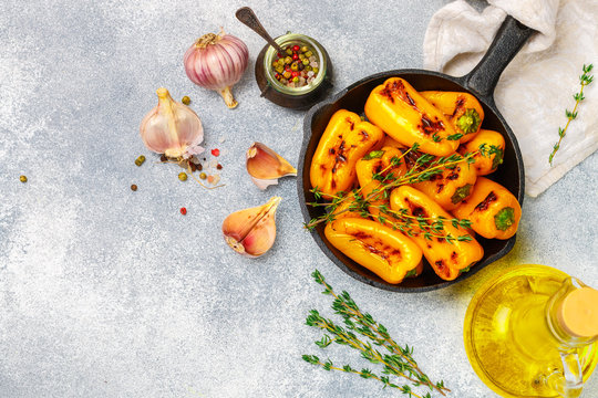 Roasted bell pepper with olive oil, garlic, thyme and spices. Gourmet snack. A side dish to meat and fish. Selective focus, copy space