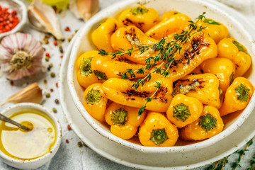 Delicatessen appetizer of roasted bell peppers with garlic, thyme and spices with olive oil. Gourmet snack. A side dish to meat and fish. Selective focus
