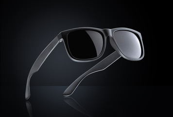 Sunglasses on black background with reflection