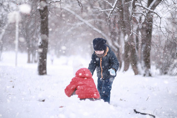 Kids walk in the park first snow