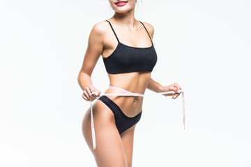 Woman measuring her slim body isolated on a white background